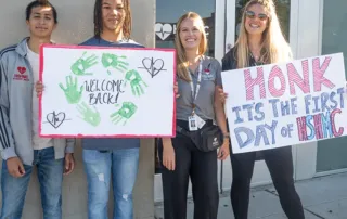 Students holding signs