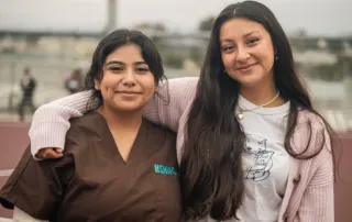 Two students pose for the camera