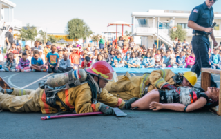 Students learning fire safety from Health Sciences High cadets during Fire Prevention Week Assembly